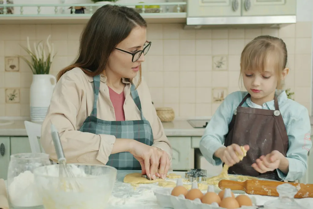 A parent and child baking together in their kitchen at home