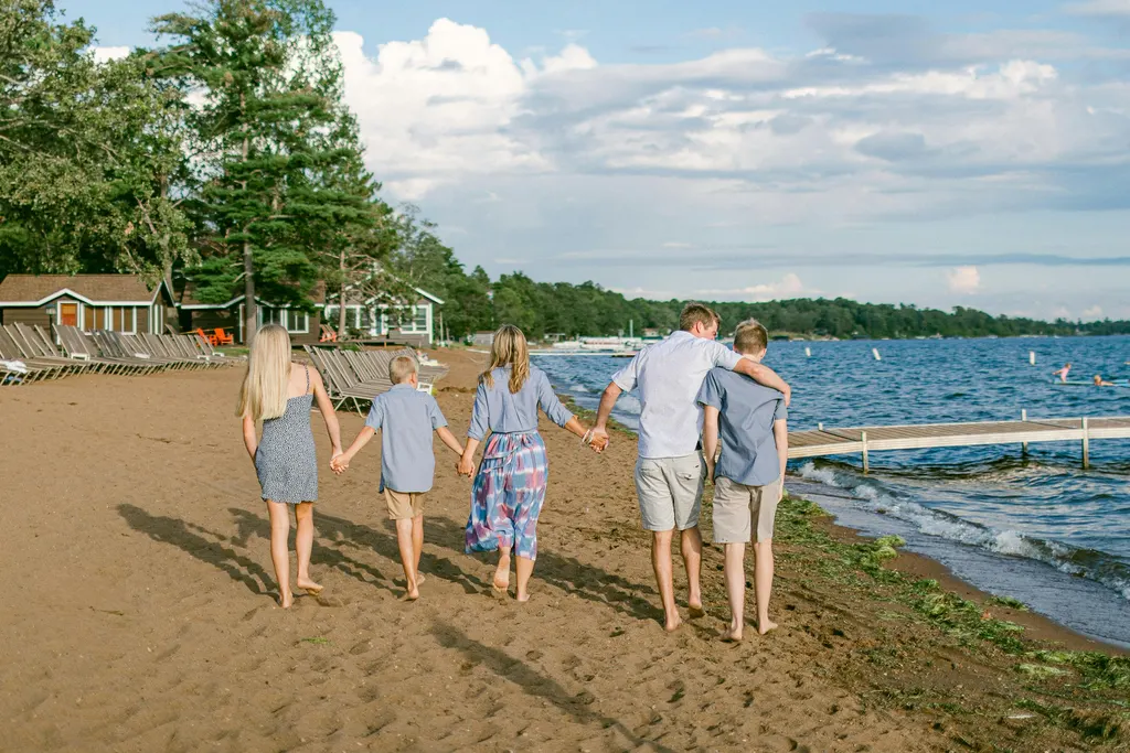 A family walking along a beach together holding hands