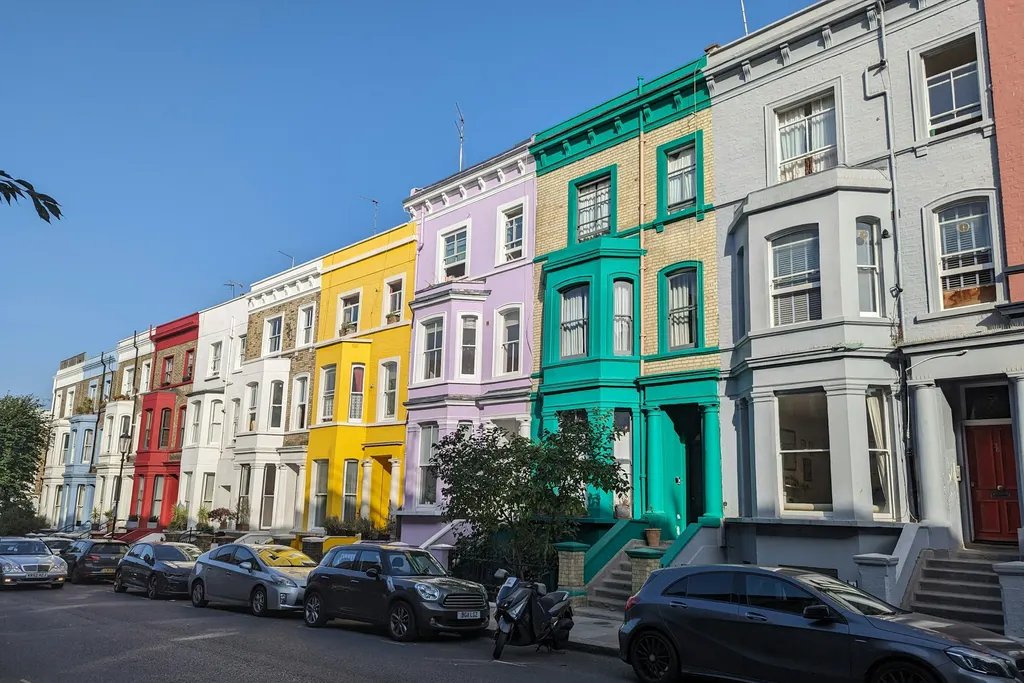 A row of painted houses in different colours on a London street